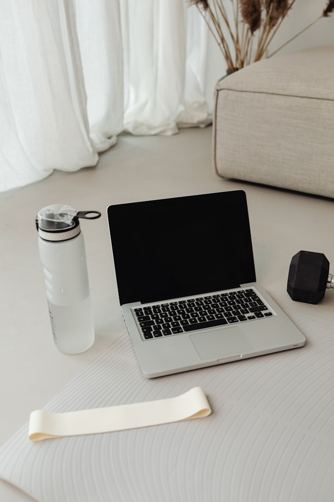 Woman following an online workout class at home on a laptop